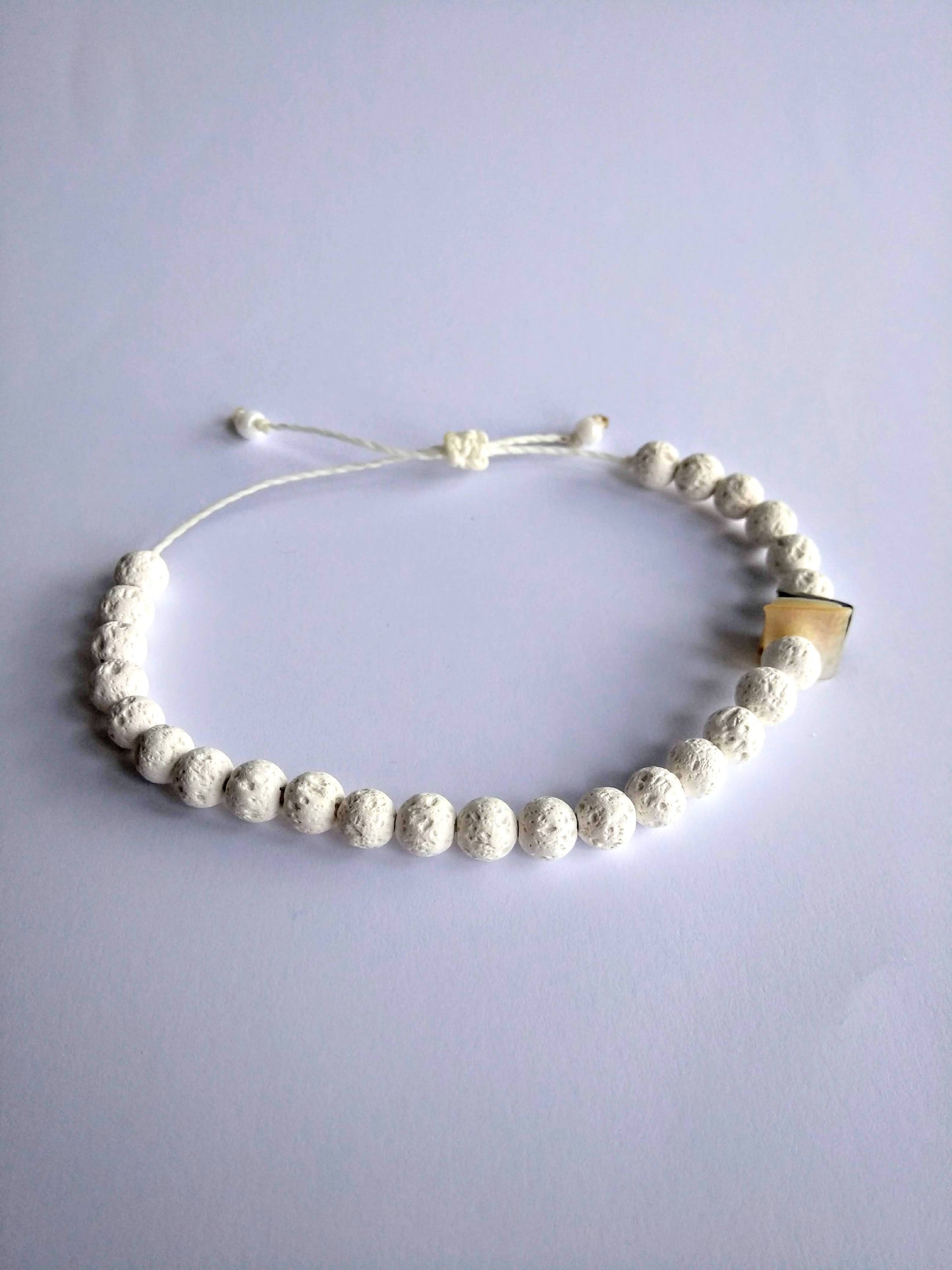 bracciale pietra lavica chips conchiglia sfondo bianco