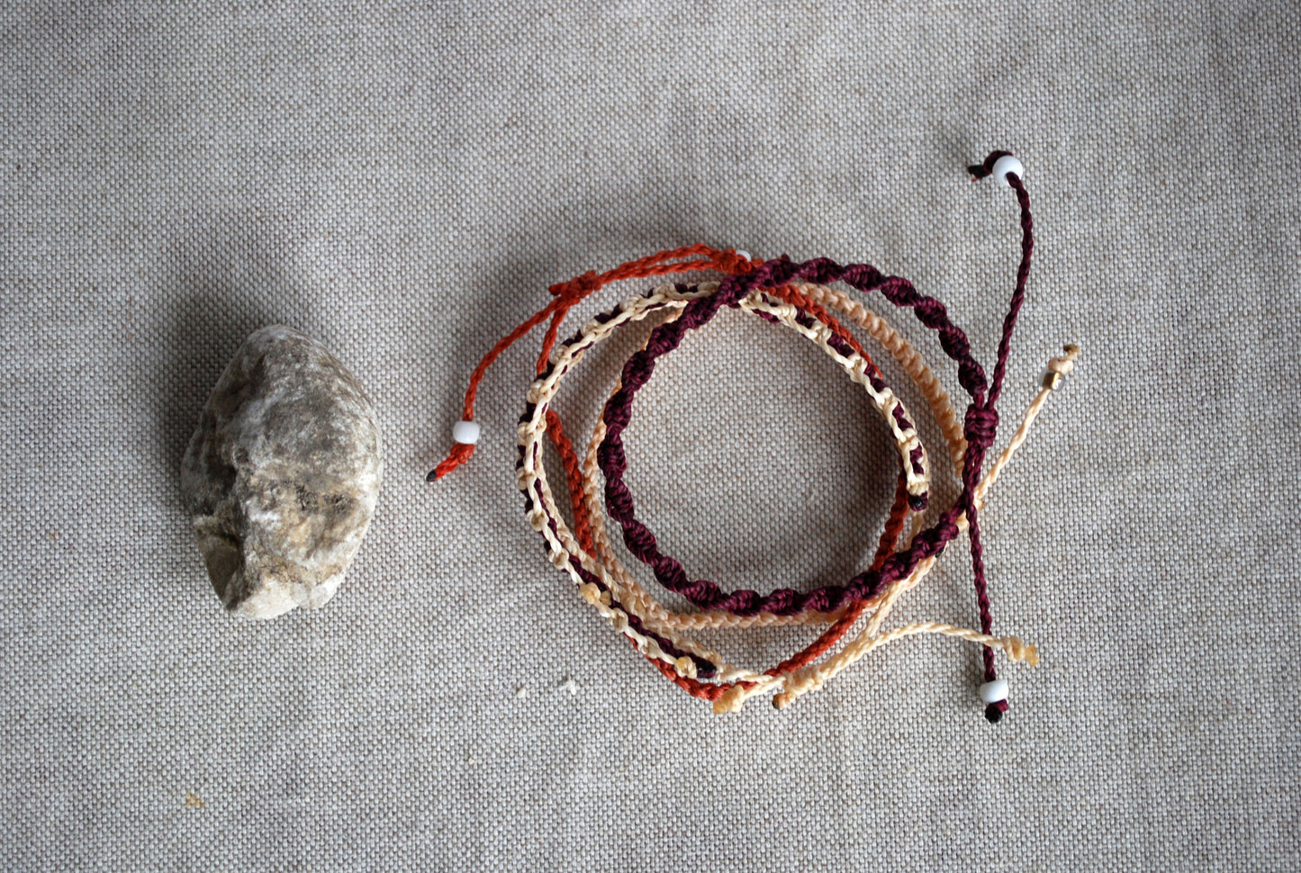 Set of four cream and aubergine macramé bracelets