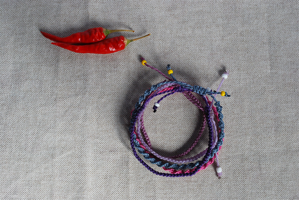 Six of five macrame bracelets in shades of purple