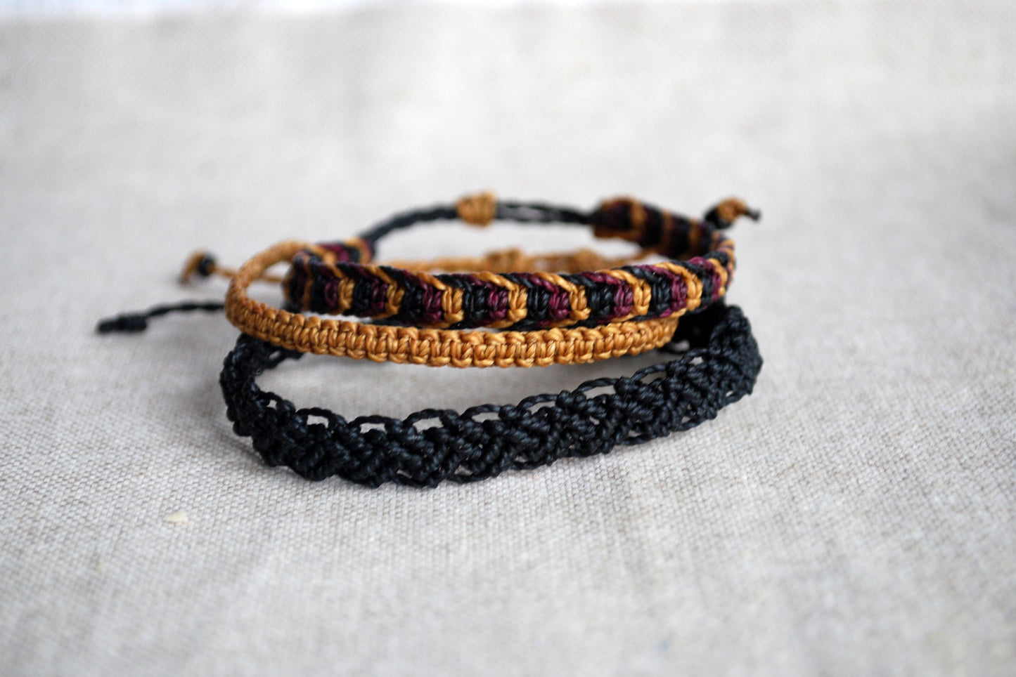 Set of three mustard and black macrame bracelets